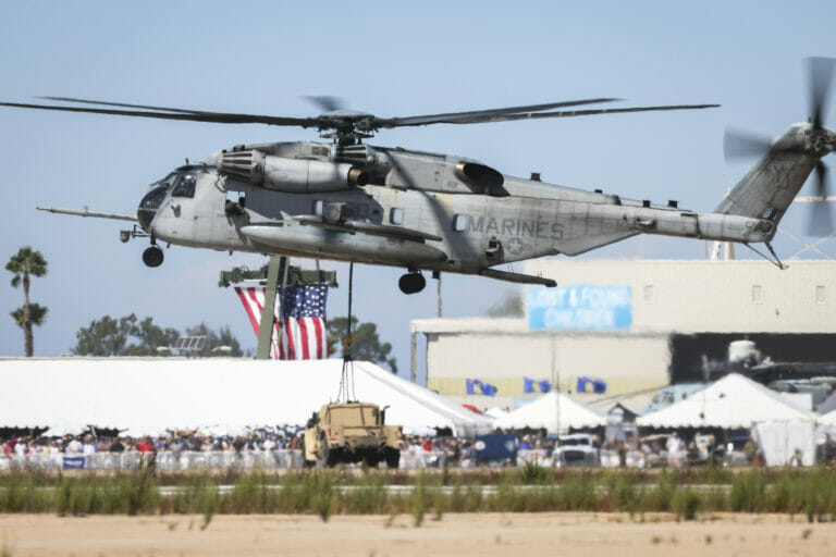 A CH-53E Super Stallion flies above the flight line during the Marine Air-Ground Task Force demonstration of the 2022 Marine Corps Air Station Miramar Air Show at MCAS Miramar, San Diego, California, Sept. 24, 2022. The MAGTF Demo displays the coordinated use of close-air support, artillery and infantry forces, and provides a visual representation of how the Marine Corps operates. The theme for the 2022 MCAS Miramar Air Show, “Marines Fight, Evolve and Win,” reflects the Marine Corps’ ongoing modernization efforts to prepare for future conflicts. (U.S. Marine Corps photo by Jose S. GuerreroDeLeon)