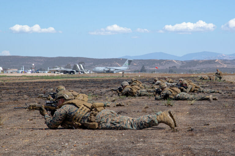 U.S. Marine Infantrymen with 3rd Battalion, 5th Marine Regiment, 1st Marine Division, provide ground security during the Marine Air-Ground Task Force demonstration of the 2022 Marine Corps Air Station Miramar Air Show at MCAS Miramar, San Diego, California, Sept. 24, 2022. The MAGTF Demo displays the coordinated use of close-air support, artillery and infantry forces, and provides a visual representation of how the Marine Corps operates. The theme for the 2022 MCAS Miramar Air Show, “Marines Fight, Evolve and Win,” reflects the Marine Corps’ ongoing modernization efforts to prepare for future conflicts. (U.S. Marine Corps photo by Cpl. Tyler W. Abbott)
