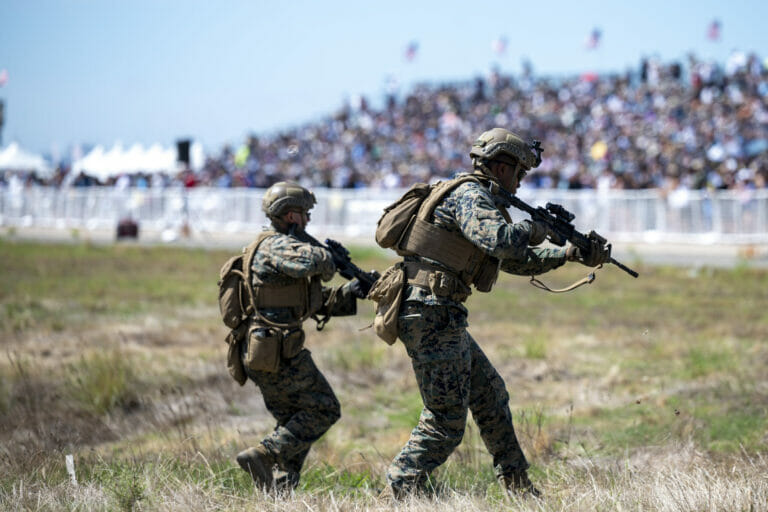 U.S. Marine Infantrymen with 3rd Battalion, 5th Marine Regiment, 1st Marine Division, provide ground security during the Marine Air-Ground Task Force demonstration of the 2022 Marine Corps Air Station Miramar Air Show at MCAS Miramar, San Diego, California, Sept. 24, 2022. The MAGTF Demo displays the coordinated use of close-air support, artillery and infantry forces, and provides a visual representation of how the Marine Corps operates. The theme for the 2022 MCAS Miramar Air Show, “Marines Fight, Evolve and Win,” reflects the Marine Corps’ ongoing modernization efforts to prepare for future conflicts. (U.S. Air Force photo by Adam Bowles)